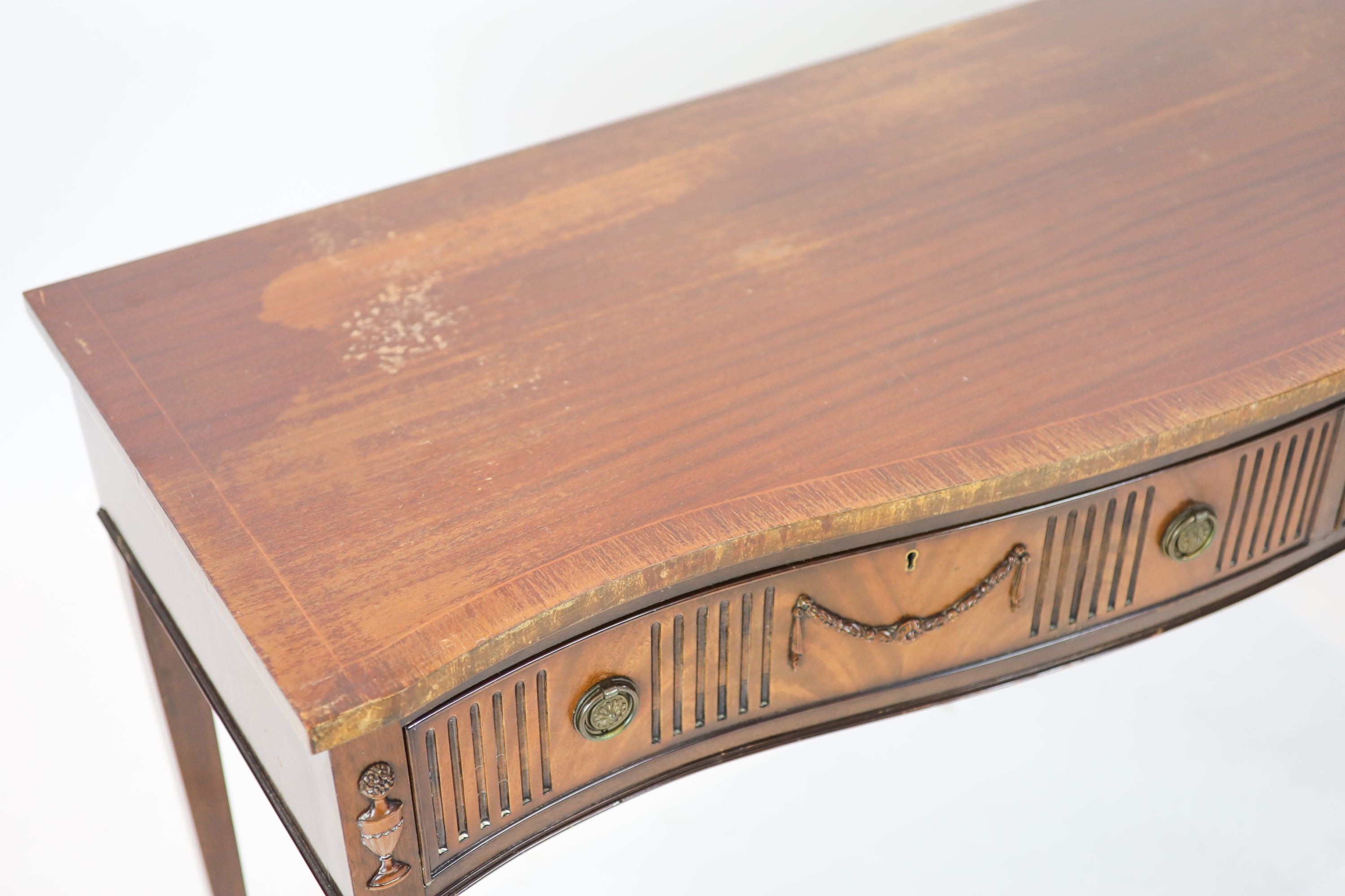 A George III style mahogany serpentine fronted serving table, width 153cm, depth 57cm height 88cm